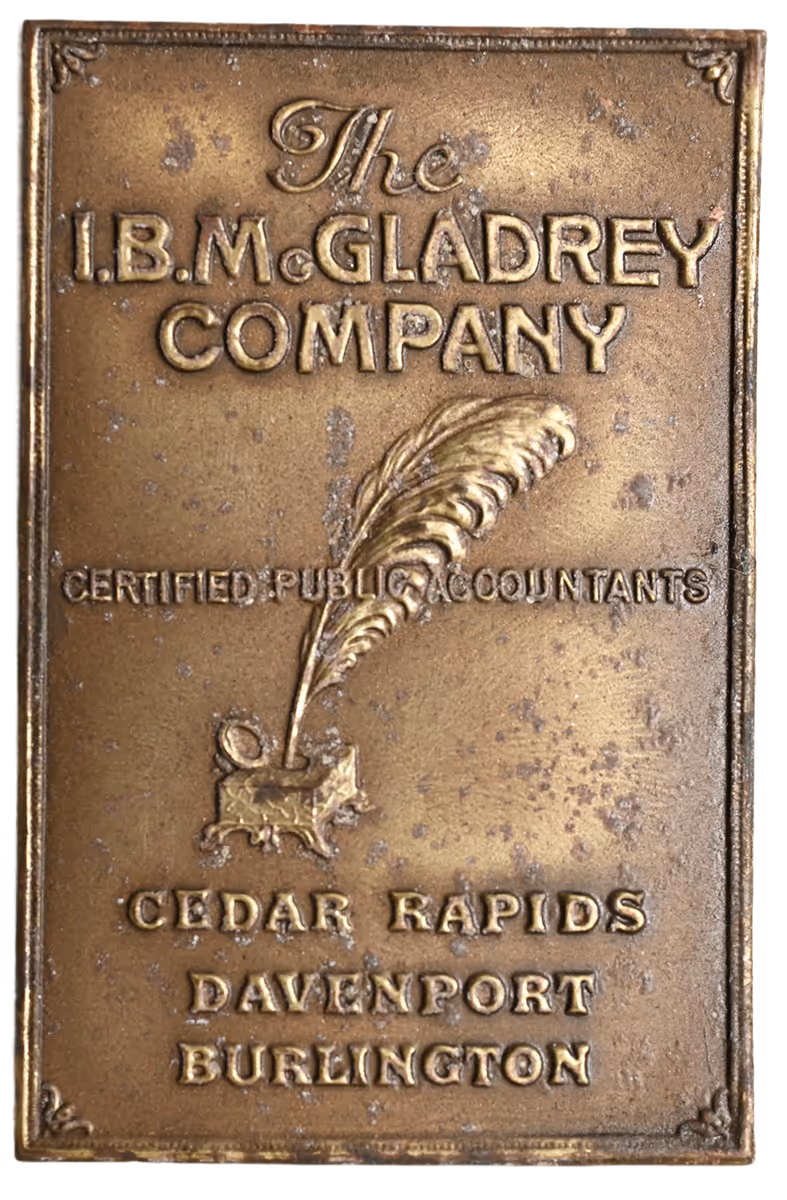 Bronze plaque reading 'The I.B.Mc.GLADREY COMPANY Certified Public Accountants' with a quill and inkpot, and locations Cedar Rapids, Davenport, Burlington.