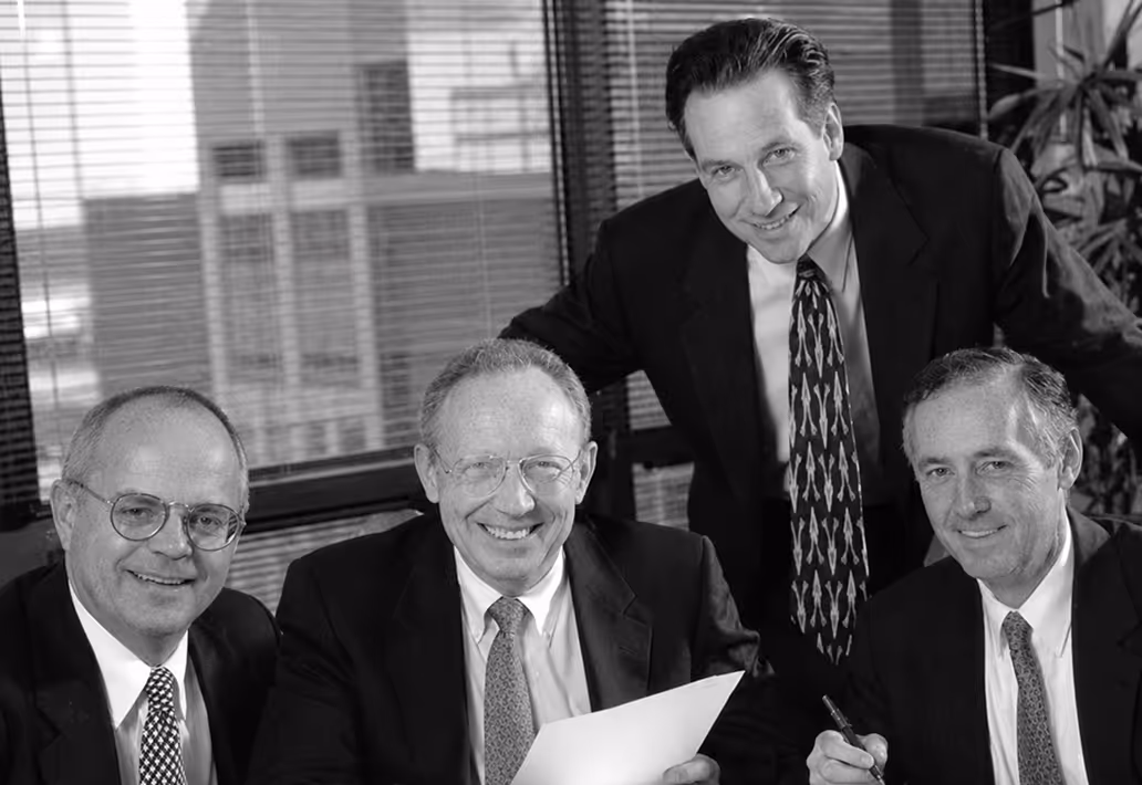 Mark Scally, Frank Salizzoni, Mark Ernst and Tom Rotherham sign the papers that make McGladrey & Pullen a separate division of H&R Block.