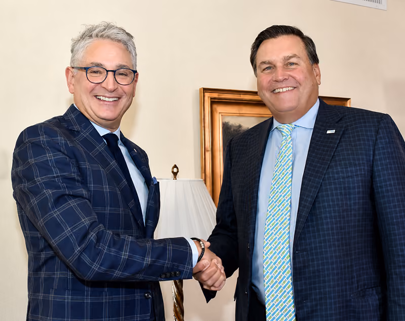 Joe Adams from RSM US shakes hands with Managing Partner of RSM Canada Harry Blum.