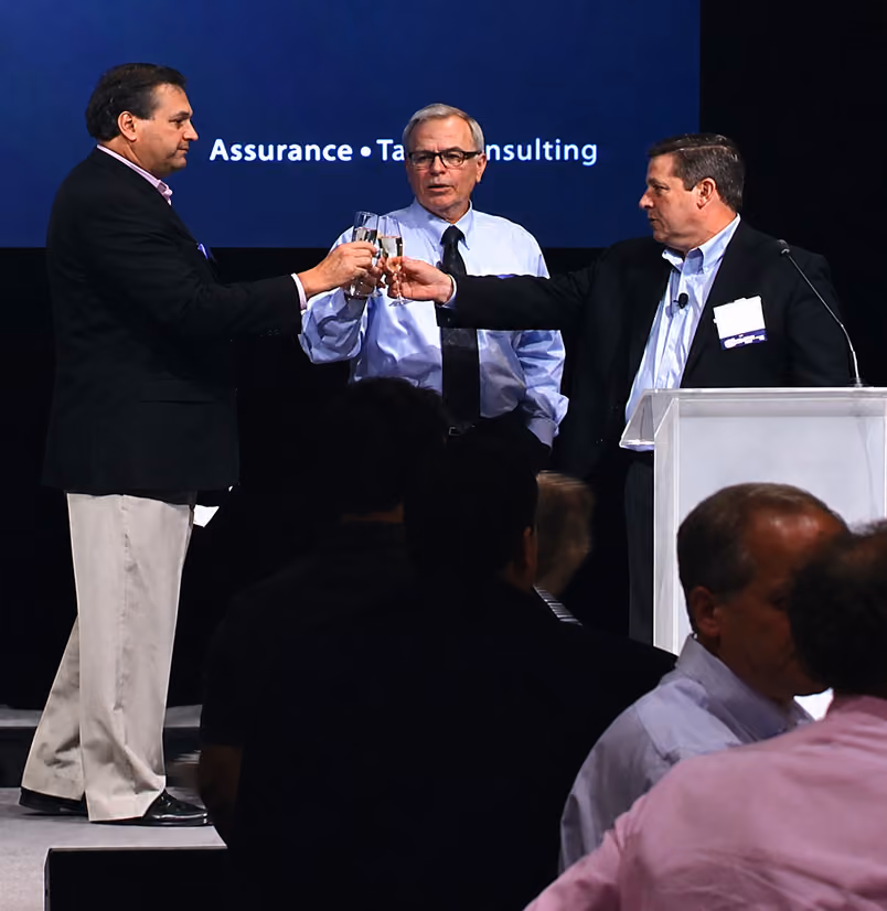 Joe Adams, Mike Kirley and Jerry Bourassa toast the partners upon the approval vote to buy the firm back from H&R Block.